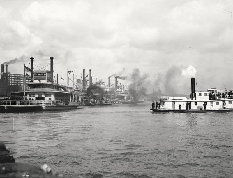 Packet steamboats and smoke plumes along the New Orleans levee.