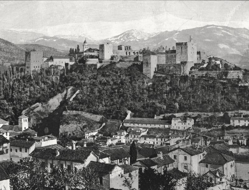 The Alhambra on its wooded hill below the snowfields of the Sierra Nevada.