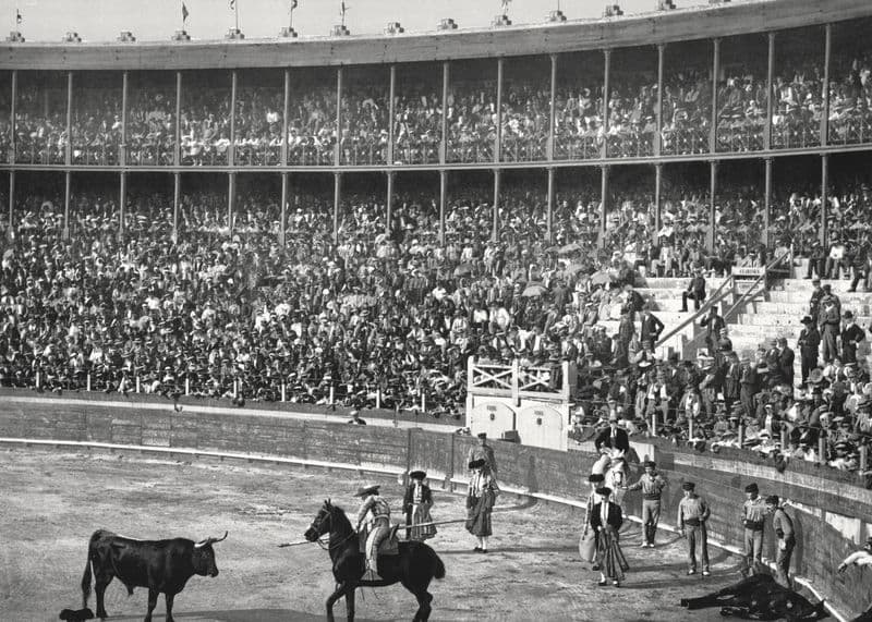 Crowded two-tier bullring during a bullfight, Barcelona, around 1900.