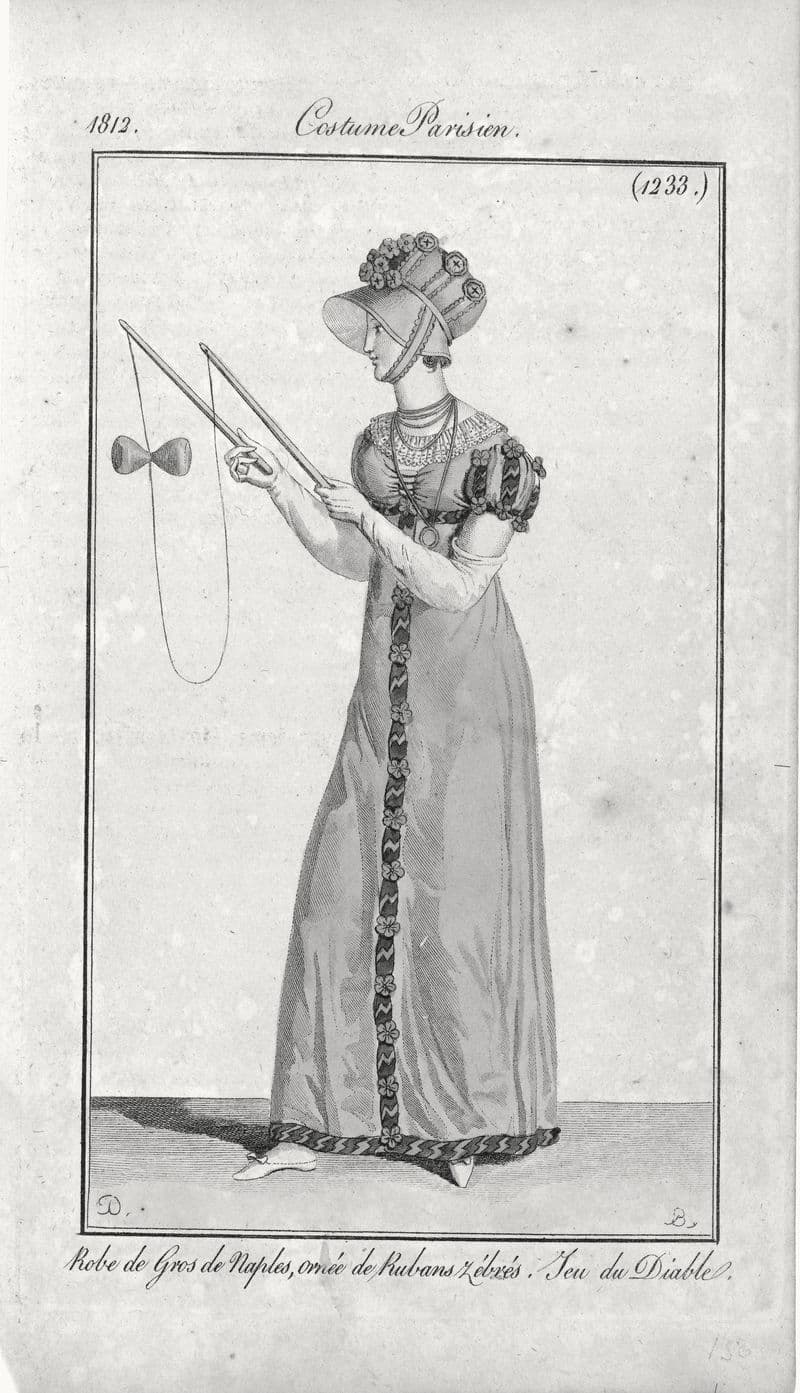 Hand-colored 1812 fashion plate of a woman in an Empire-line gown playing diabolo.