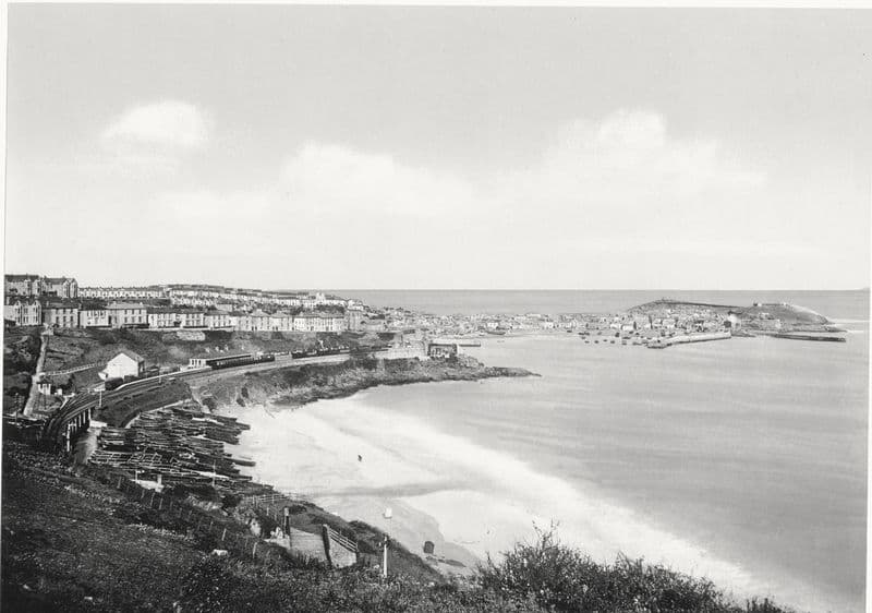 St Ives and its bay seen across the curve of Porthminster beach, Cornwall.